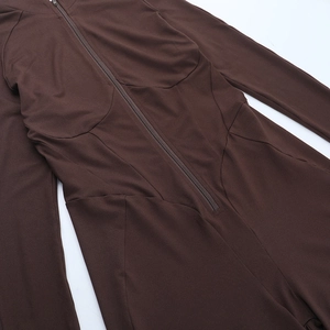 Detailed macro view of the front zipper closure and ribbed texture on the brown bodysuit
