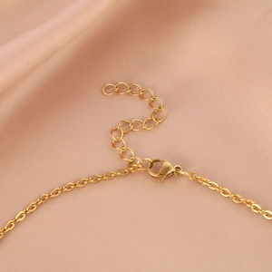 Minimalist gold leaf necklace featuring a lobster clasp and adjustable extension chain