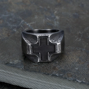 Vintage stainless steel cross ring in antique silver finish on a rugged grey stone