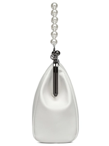 Close-up of white satin evening clutch bag with elegant pearl handle and metal clasp