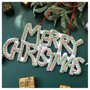 Detailed view of Merry Christmas lettering ornament with red and green candy cane texture