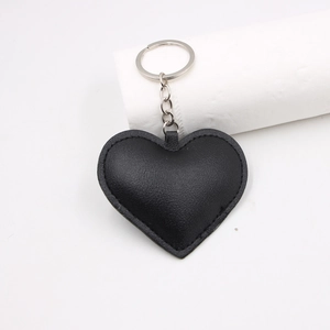 Minimalist black heart leather keychain with metal ring and neat stitching for bags