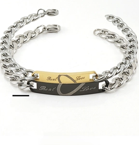 Detailed view of Real Love engraved plaques and heart icons on stainless steel bracelets
