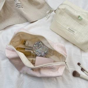 Detail of floral makeup bag showing large capacity for skincare and cosmetic storage