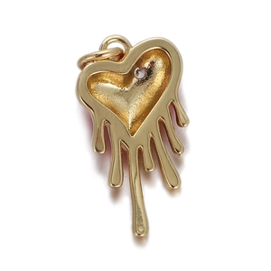 Detailed view of a gold heart-shaped pendant with polished finish on a white background
