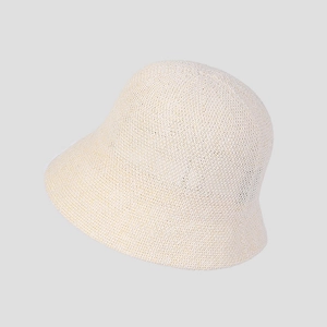 Detail of breathable knitted texture and soft beige fabric on the sun bucket hat