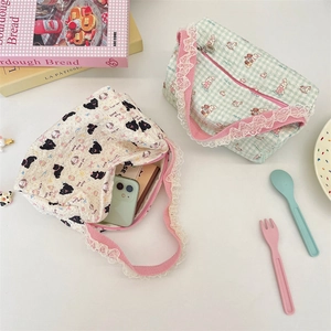 Detail of cartoon canvas tote bag with lace trim and cute kitty print showing phone capacity