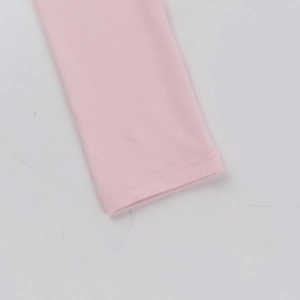 Close-up of pink long sleeve cuff showing precise double-needle stitching and fabric