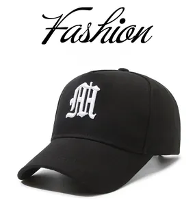 Close-up of white 3D gothic letter M embroidery on black cotton twill baseball cap
