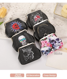 Gothic punk coin purse with skull print and vintage metal clasp displayed on lace