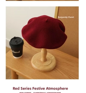 Detailed view of a claret Australian wool beret placed on a wooden hat stand for winter