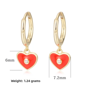 Detail view of gold S925 heart earrings with red enamel inlay and white zircon stone