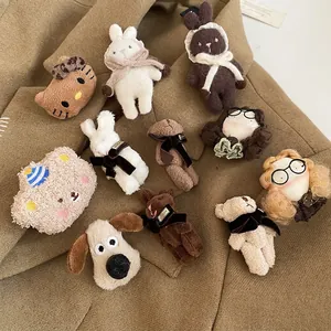 Cute flocked cartoon bear and kitten brooches in warm brown tones on khaki fabric