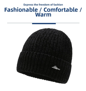 Detail of black knit beanie with white embroidered script on textured ribbed fabric