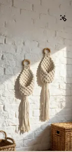 Close-up of bohemian hand-woven cotton rope wall hanging with elegant tassel detail