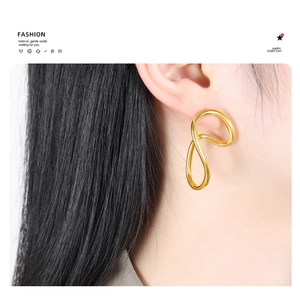 Detailed view of irregular 18K gold plated hoop earrings with fluid geometric lines