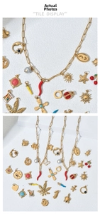 Detailed tile display of gold charms including sun, moon, star, and maple leaf motifs