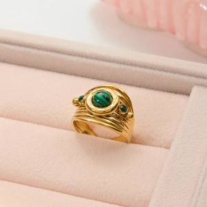 Vintage layered gold titanium steel ring with green malachite stone on pink velvet