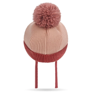 Warm winter knit baby hat with large pompom and earflaps in pink and red tones