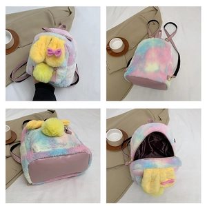 Detail of rainbow plush rabbit backpack with pink straps and soft inner lining