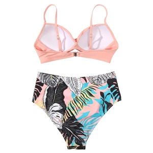 Detailed flat lay of high-waisted bikini set with pink top and tropical leaf print bottom