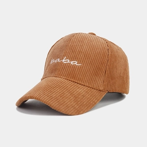 Detailed close-up of corduroy fabric texture and baba embroidery on the baseball cap