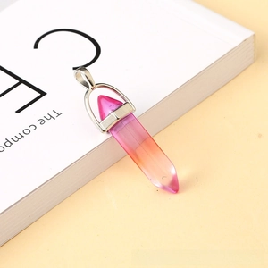 Macro shot of gradient hex crystal pendant with rose red and orange polished resin surface