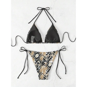 Flat lay detail of snakeskin print bikini featuring metallic eyelets and side-tie design