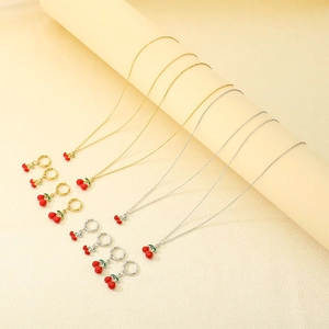 Detailed set of cherry pendants in gold and silver finish with red enamel fruits
