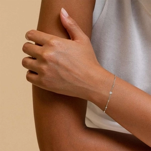 Detail of minimalist S925 sterling silver beaded bracelet with sparkling rhinestones on wrist