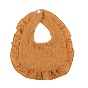 Ruffled cotton muslin baby bib in ginger yellow with snap closure on white background