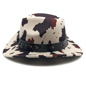 Detail of cow print cowboy hat showing felt texture and studded leather band decor