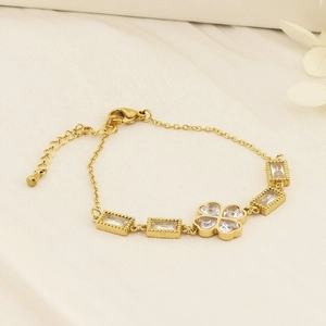 Detail of gold clover bracelet with rectangular zircon settings and lobster clasp