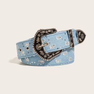 Vintage blue denim belt with ornate silver buckle and rhinestones on white background