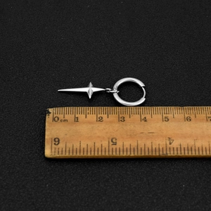 Minimalist stainless steel star drop earrings in silver, length 4.5cm shown with ruler