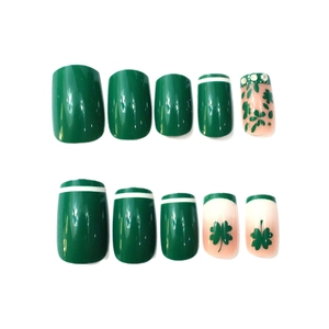 Short square press-on nails in green and nude colors with clover patterns and rhinestones