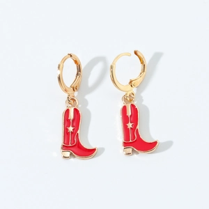 Detail of red enamel western cowboy boot earrings with golden star accent on white background