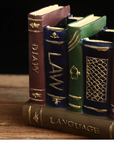 Detail of vintage resin book-shaped pen holder with aged leather texture and engravings