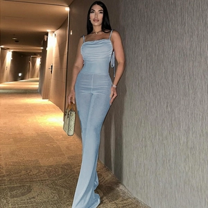 Detail of the light blue backless jumpsuit featuring ruched bust and flared leg trousers