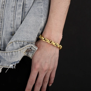 Detail of vintage gold curb chain bracelet with toggle clasp on male model