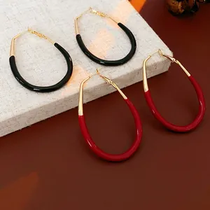 Chic oval horseshoe hoop earrings with black and red enamel finish in gold plating