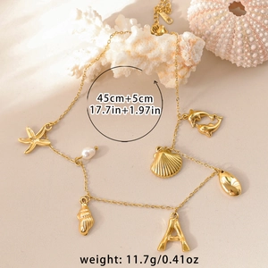 18k gold plated sea life necklace with alphabet A pearl and starfish charms on beige coral