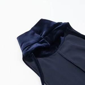 Detailed close-up showing the rich texture of dark blue velvet fabric and fine stitching