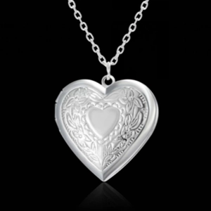 Detailed silver heart locket necklace with floral engraving and center heart detail