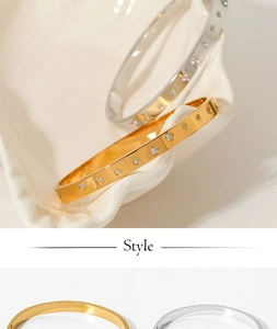 Close-up of gold and silver stainless steel bangles with sparkling pave zircons