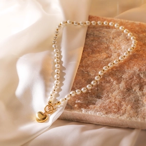Minimalist gold-plated heart pendant pearl necklace with OT clasp on marble stone