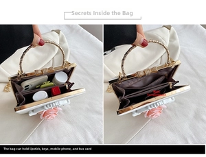 Detail view of white baroque evening bag with 3D rose and pearl bow ring handle
