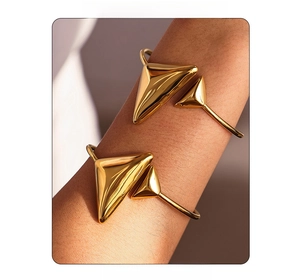 Close-up of 18K gold-plated stainless steel triangle open bangle worn on a female wrist