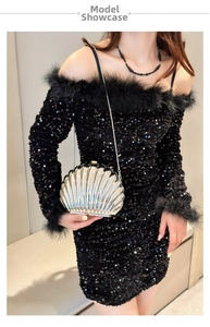 Detail of shell-shaped evening clutch bag with metallic ribs and metal chain strap
