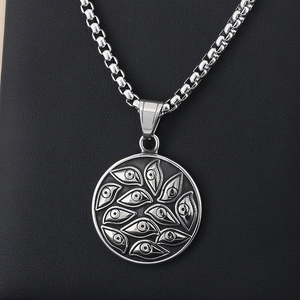 Macro detail of punk style stainless steel evil eye pendant on textured leather background